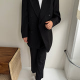 Double breasted grey suit with green pinstripes