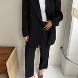 Double breasted grey suit with green pinstripes